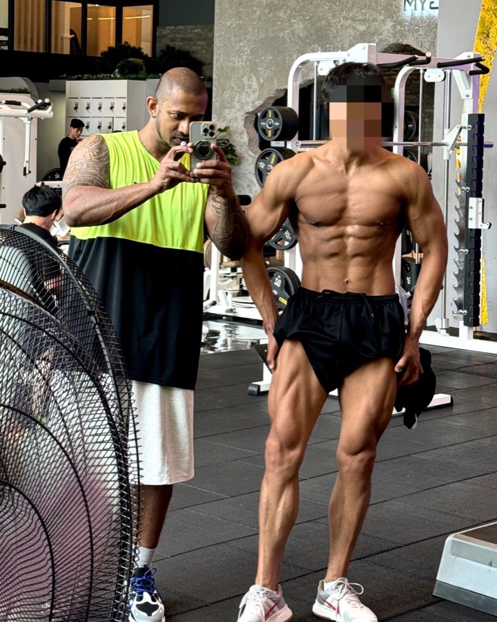 Coach Vinzy photographing a client's physique progress